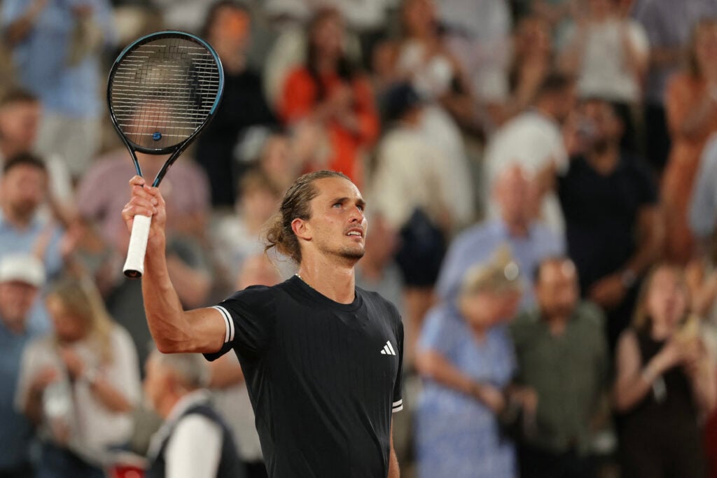 Alexander Zverev waves to the crowd at Roland Garros.