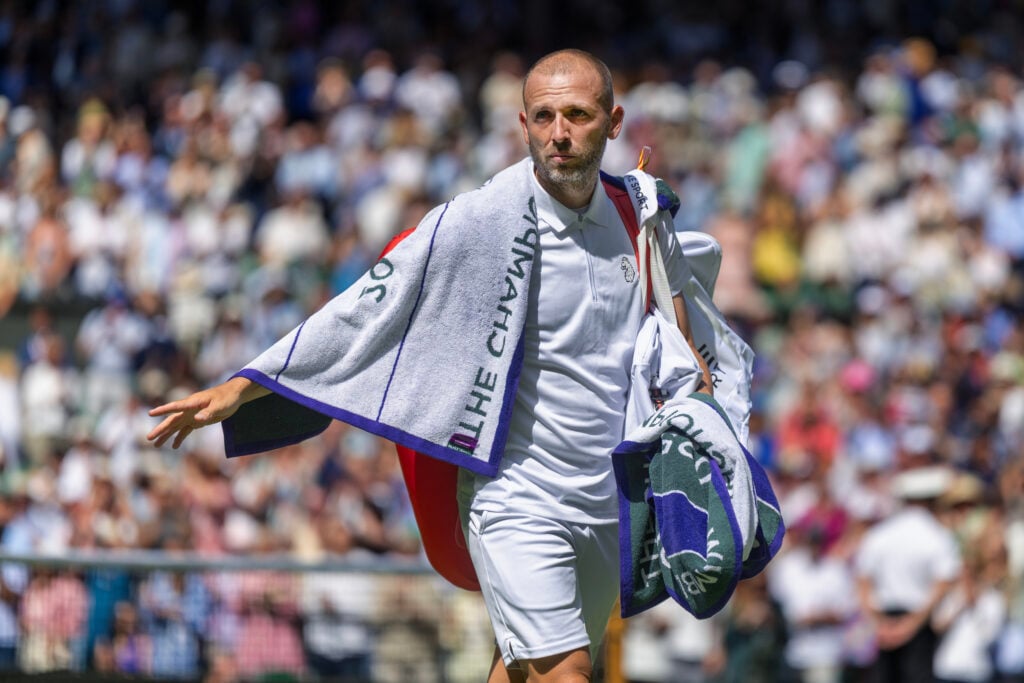 Dan Evans walks off court after losing to Novak Djokovic at Wimbledon in 2025.