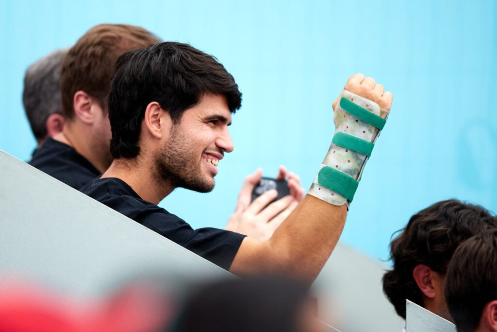 Carlos Alcaraz celebrates in the stands at the Madrid Open.