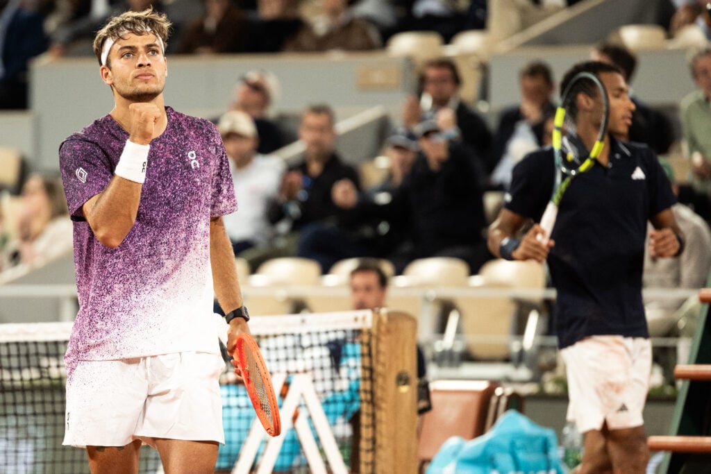 Flavio Cobolli pumps his fist at Roland Garros.
