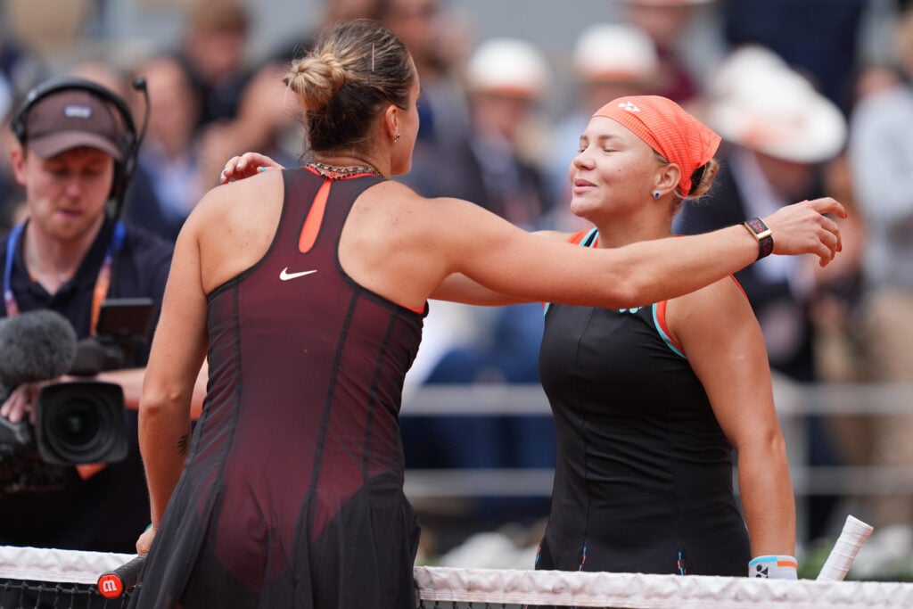 Diana Shnaider hugs Aryna Sabalenka after beating her at Roland Garros in 2026.