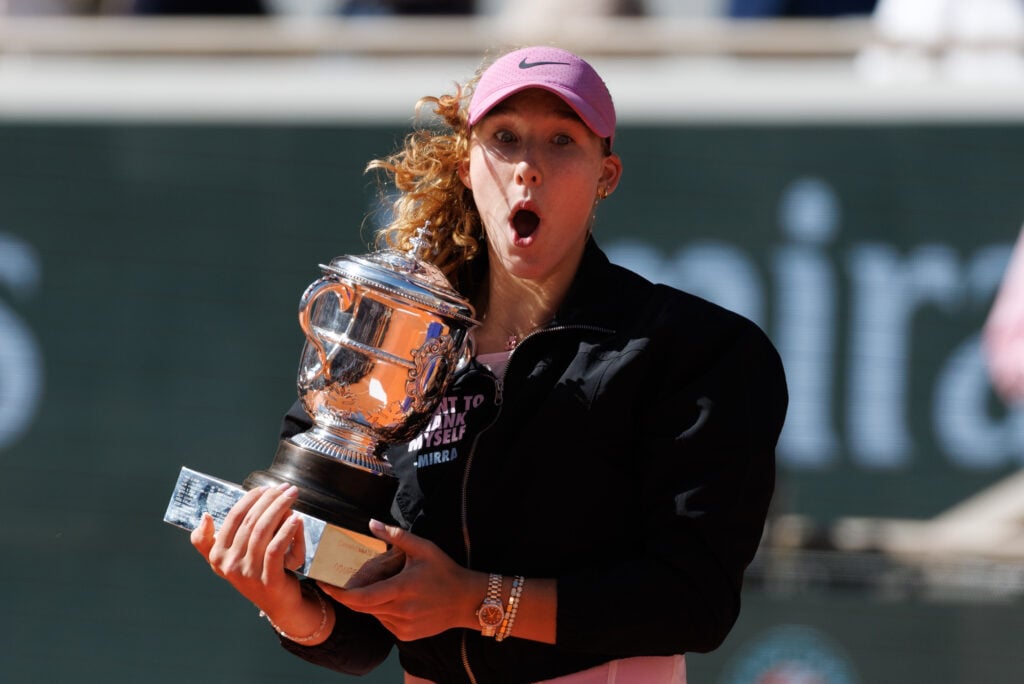Mirra Andreeva reacts while holding the Roland Garros trophy.