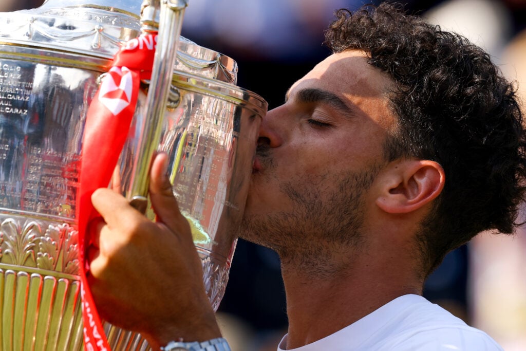Francisco Cerundolo kisses the Queen's title.