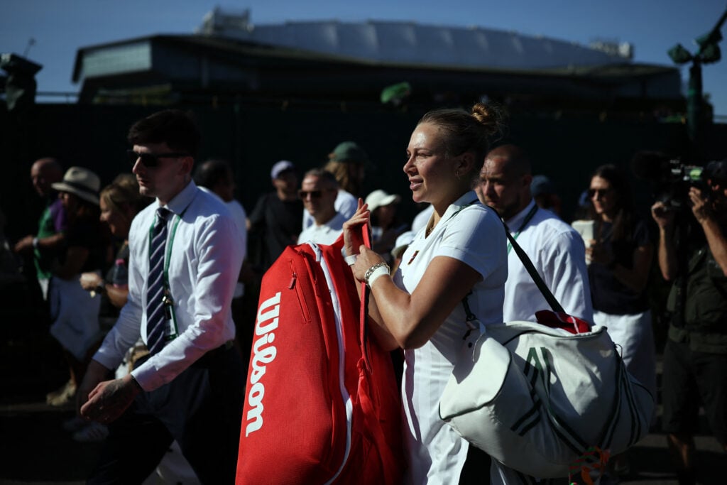 Amanda Anisimova leaves the court at Wimbledon.