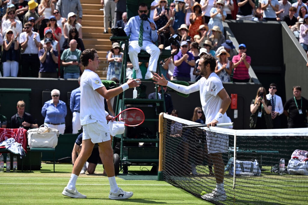Roman Safiullin and Joao Fonseca shake hands.