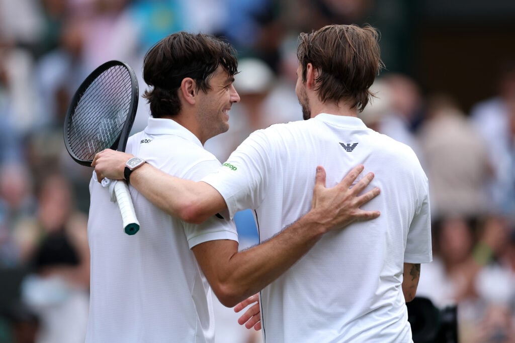 Taylor Fritz and Alexander Bublik embrace at Wimbledon.