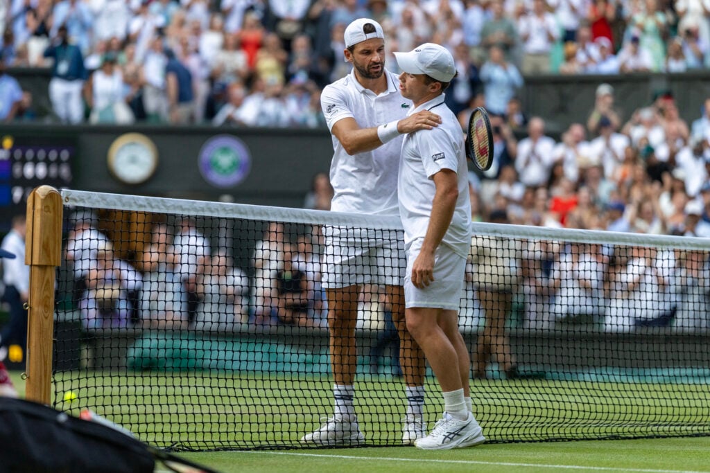 Grigor Dimitrov and Arthur Fery embrace.