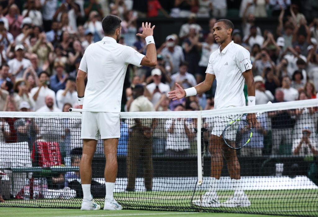 Novak Djokovic and Felix Auger-Aliassime shake hands at Wimbledon.