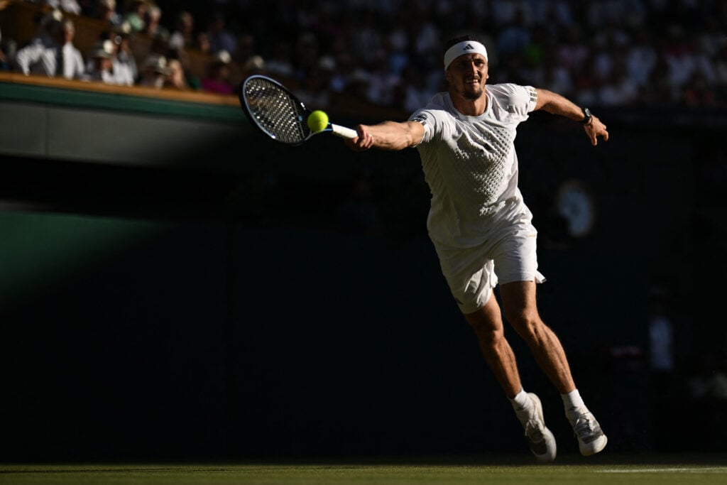 Alexander Zverev returns in the Wimbledon final.