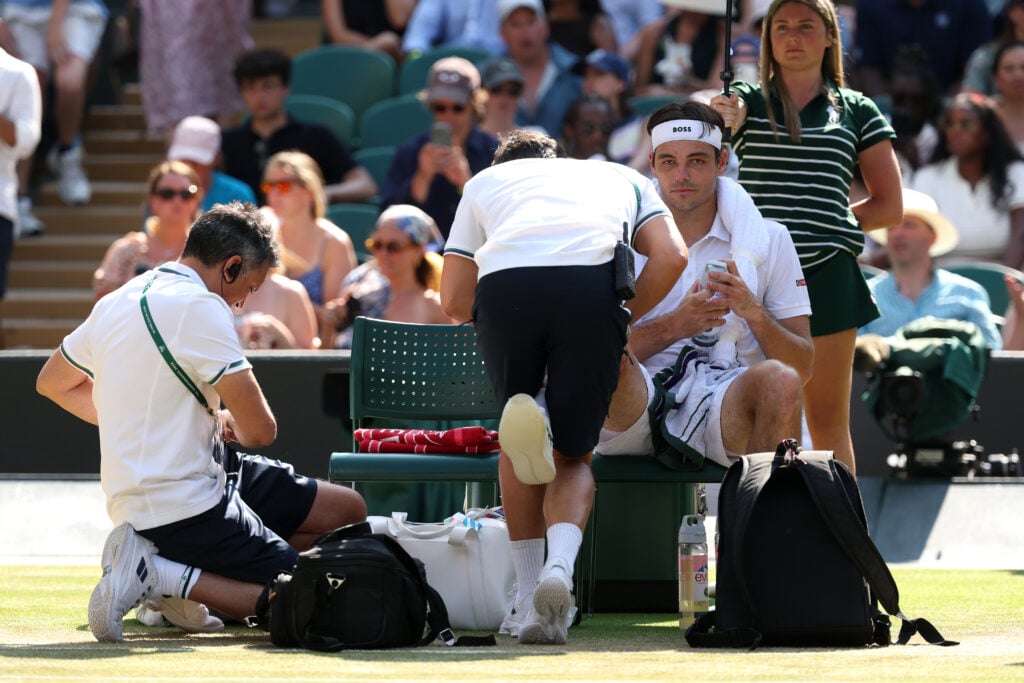 Taylor Fritz recieves medical treatment at Wimbledon.