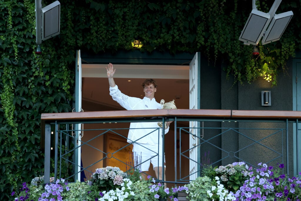 Jannik Sinner waves to the crowd after winning Wimbledon.