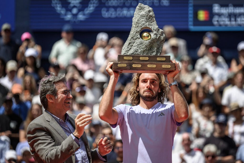 Stefanos Tsitsipas holds the Swiss Open title aloft.